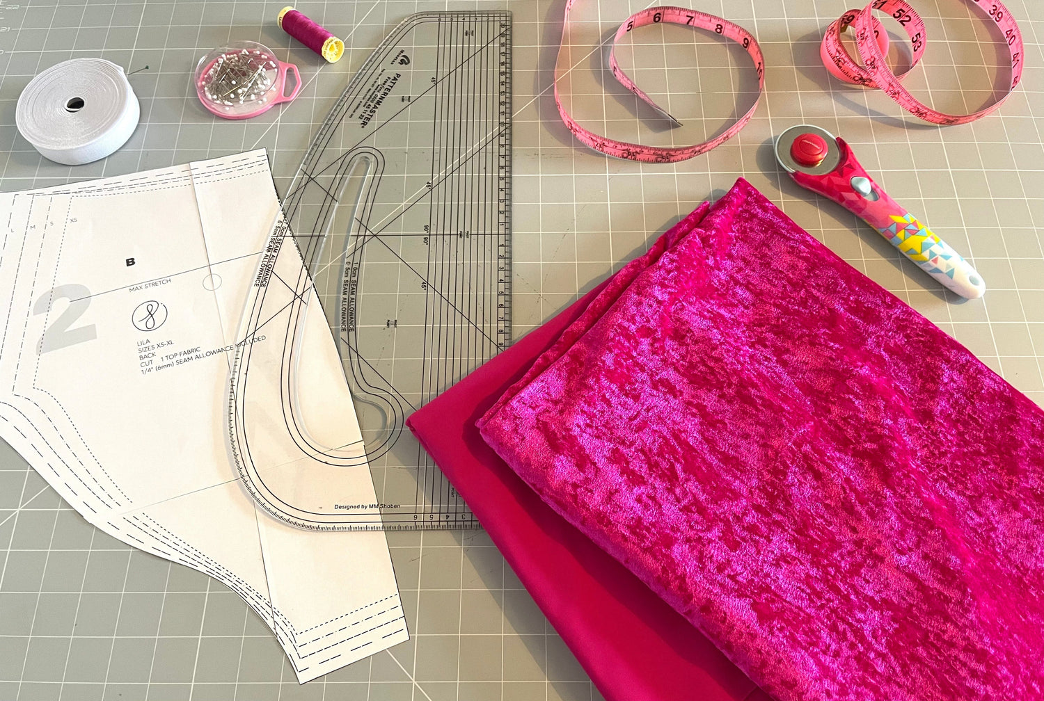 Dancewear sewing pattern with stretch fabric and tools ready for dance costume making
