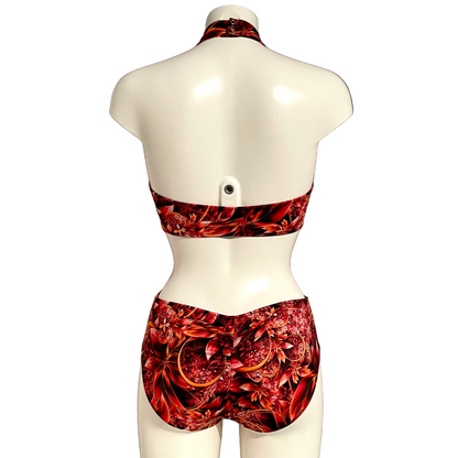 Mannequin wearing a red floral leotard against a white background